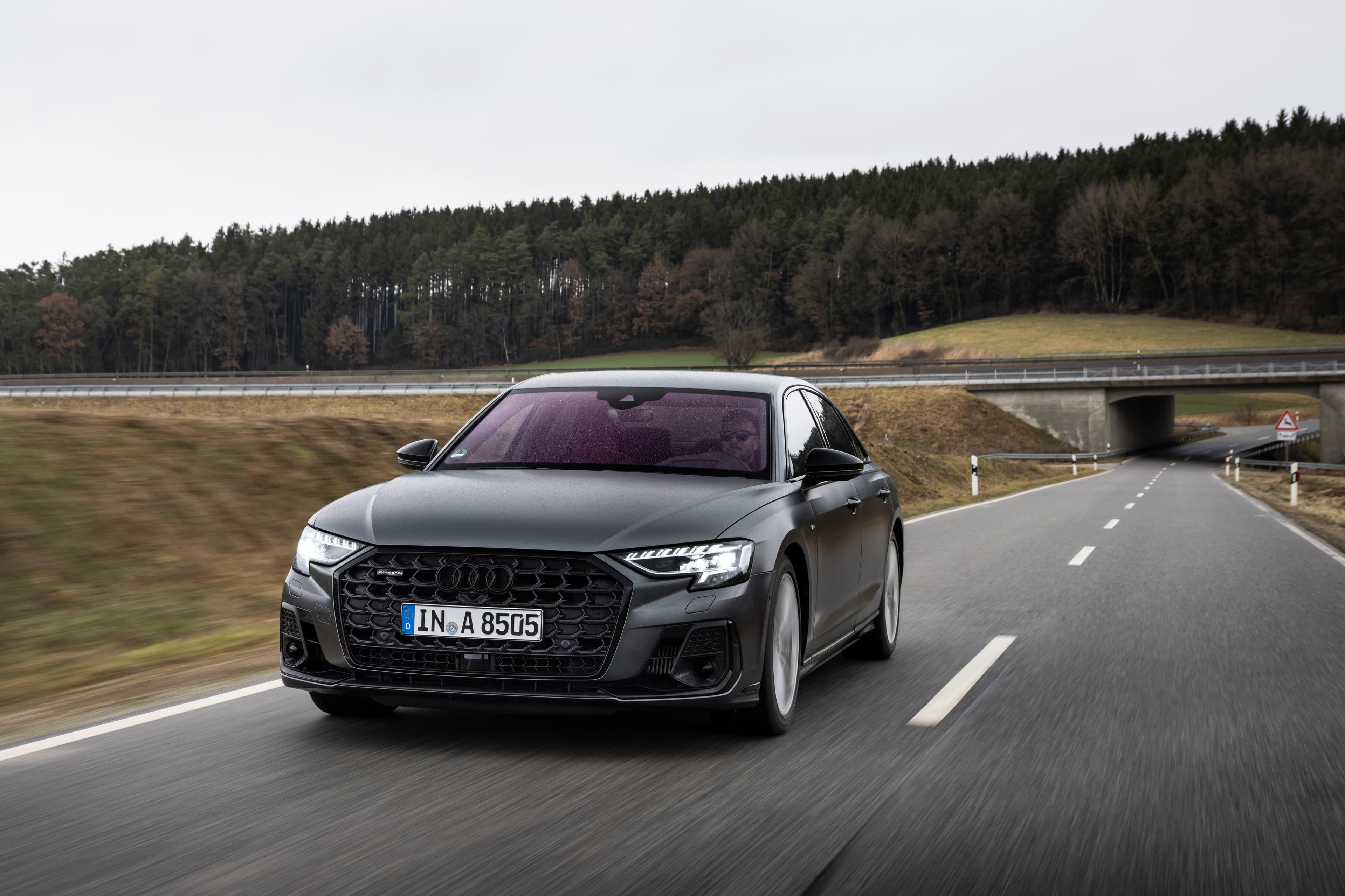 Pilkas Audi A8 D5, priekinis trijų ketvirčių vaizdas kelyje